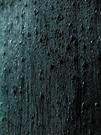 water drops on the black wooden background, close-up, macroの写真素材