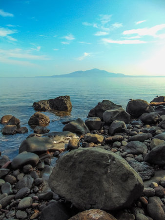 A beautiful sea view in the morning. Sea, mountains, and sky in the Manado area, Indonesia.の写真素材