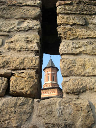View of a church tower through a gapの写真素材