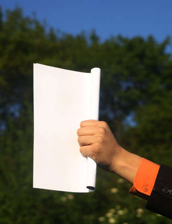 Business man in suit holdin white paperの写真素材