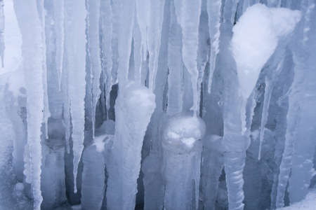 Blue icicles background with little snowの写真素材