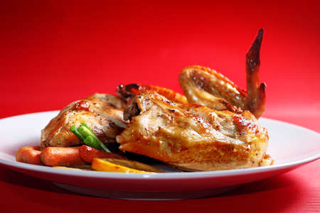 Roast chicken on a red backgroundの写真素材
