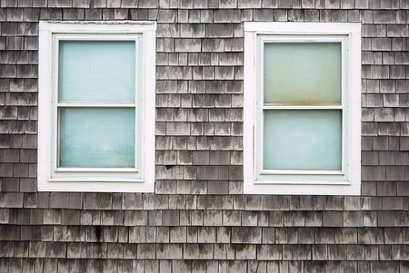 Two white windows on a old cedar wallの写真素材