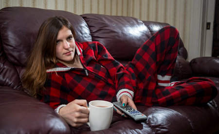 Woman in Red Plaid Pyjama Relax on Couchの写真素材