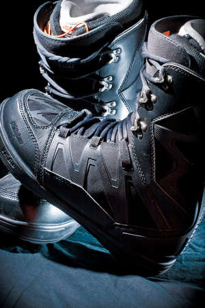 KELOWNA, CANADA - SEPTEMBER 5 2011 : Thirty Two Brand of Mens Snowboarding Boots in Black Color on a Dark Backdrop in illustrative editorial imageのeditorial素材