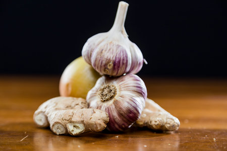 Onion Garlic and Ginger on Dark Background