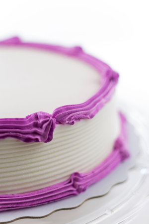 Cake with plain frosting and space for text on a bright backgroundの写真素材