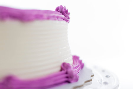 Cake with plain frosting and space for text on a bright background