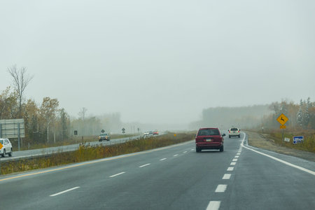 the view down a scenic country roadway in autumn landscapeの写真素材