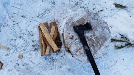 axe and cut logs for wood fire in winter