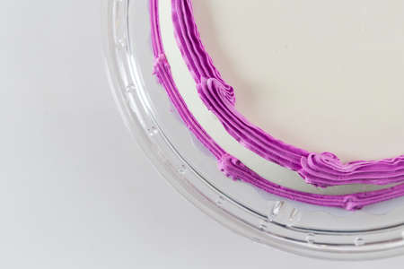 Cake with plain frosting and space for text on a bright backgroundの写真素材