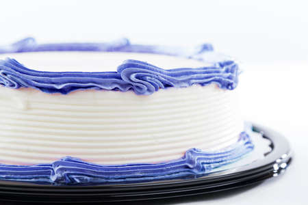 Cake with plain frosting and space for text on a bright backgroundの写真素材