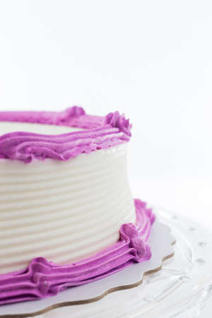 Cake with plain frosting and space for text on a bright backgroundの写真素材