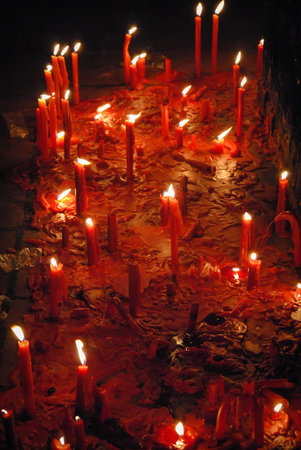 Red candles lit for the veneration of popular saints. In this case, the Gaucho Gil sanctuary