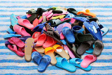 Piles of shoes sold in various color combinations rural land market, sandals, casual shoes, old.の写真素材