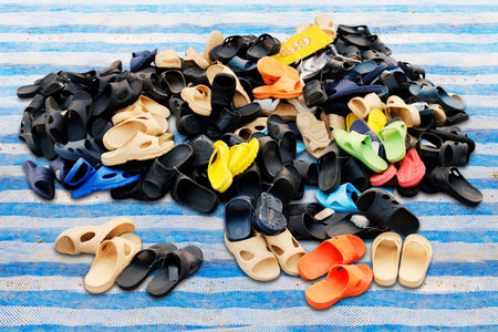 Piles of shoes sold in various color combinations rural land market, sandals, casual shoes, old.