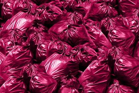 Background garbage dump, Bin,Trash, Garbage, Rubbish, Plastic Bags pile, Garbage bags pink purpleの写真素材