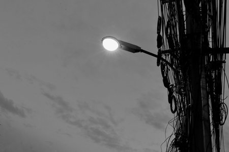 Street lights mounted on poles at evening timeの写真素材