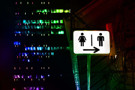Signs night bathroom, toilet sign male - female, signs, lights, signs, signs for toilets in pubs - public house, night parties and multicolored lightsの写真素材