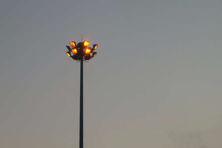 Light orange pole big on the highway, superhighway lighting column at night.の写真素材