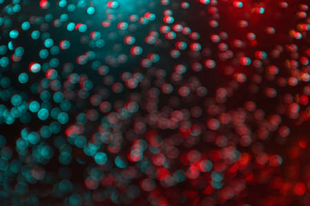 Abstract blurred Bokeh light blue and red glittering for night backgroundの写真素材