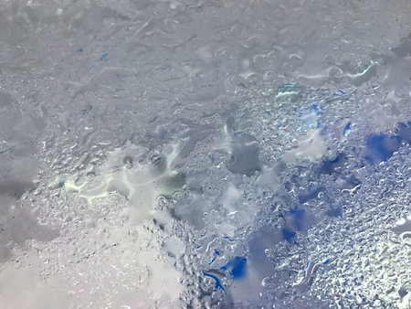 Top view of Mirror glass the dump ice bucket with water steam bubble drop wet condensationの写真素材