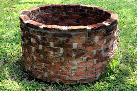 Old red brick pond loop sphere, Cement old pond circle, coterie, ambit in gardenの写真素材