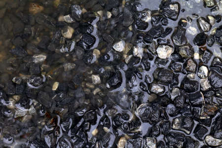 Stone wet for construction, wet Stone blue dark background, Rocks wet water for construction workの写真素材
