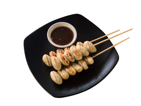 Meatballs grill and sauce in the black plate isolated White background