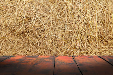Straw background texture, Wooden floor plank table empty on dry rice straw wall background for copy text space, Straw and wood plankの写真素材