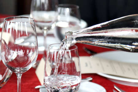 glass of water and bottle pour water in glass, cold water, water drinkの写真素材