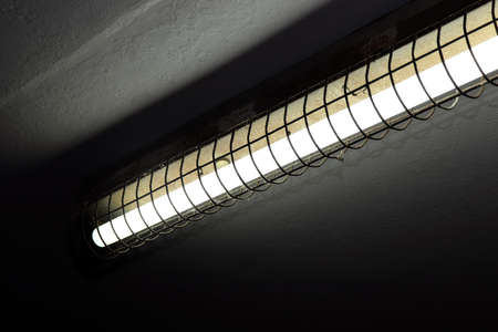 old fluorescent lamps on the ceiling, fluorescent lamps in dark, neon light, fluorescent light bulb as electric energyの写真素材