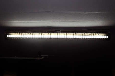 old fluorescent lamps on the ceiling, fluorescent lamps in dark, neon light, fluorescent light bulb as electric energyの写真素材