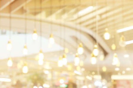 blurred light yellow gold bokeh Inside the mall luxury for background, bokeh golden abstract light shine background blurの写真素材