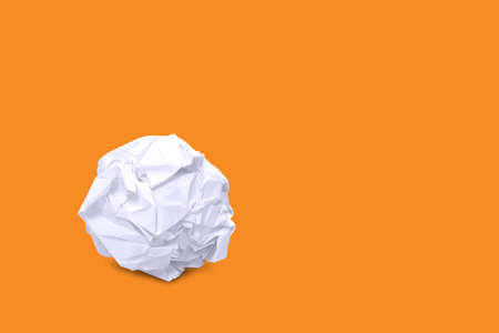 crumpled paper ball white on orange background and copy space, rough paper ball isolated on orange background, white paper ball wasteの写真素材