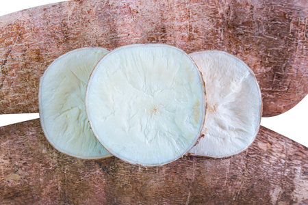 cassava tubers fresh sliced isolated on white, pile cassava manioc in top view, yucca root for flour...