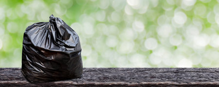 plastic garbage bag on wood plank for background, trash bag package for recycle waste, bag plastic...