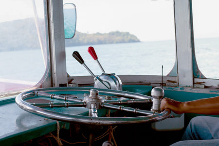 steering wheel ship and hand of boat driver inside the boat, steering wheel ship with hand holding,...