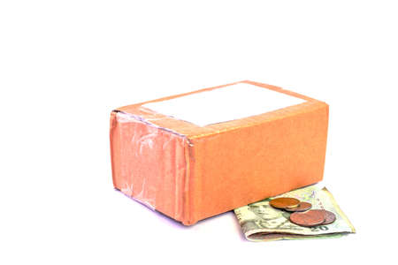 parcel post box and money banknote thai baht on white, money and cardboard box for shipping service concept, carton box packing and banknote for purchase sell conceptの写真素材
