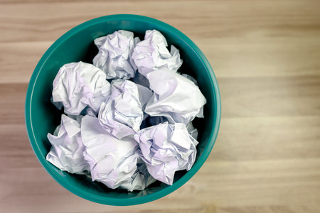 crumpled paper ball in trash can, paper waste, trash bin in office with crumple paper ball, work hard ideas conceptの写真素材
