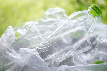 plastic waste, clear bottles in a trash bag, reflecting the plastic waste issue, represents...
