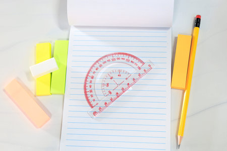 Stationery flat lay with notebook, ruler, pencil and colorful sticky notes on light background....