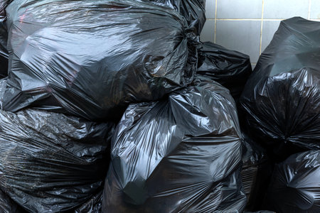 waste, pile of black garbage bags, plastic waste problem and environmental pollution, plastic waste, suitable for recycling and waste management conceptの写真素材