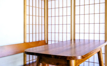 Wooden table in front of Japanese shoji screen with soft natural light. Minimal zen interior...