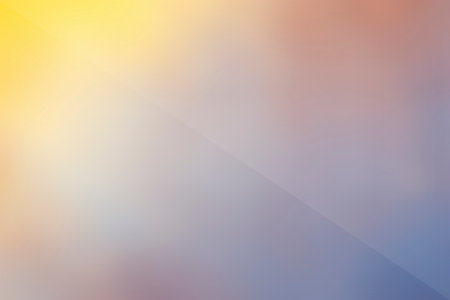 A soft, blurred background with a gradient blending warm yellow and orange tones with cool blue and purple hues, marked by a diagonal line.の写真素材