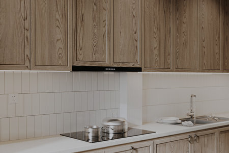 A white and wooden Island with a stove and utensils in the kitchen.の写真素材