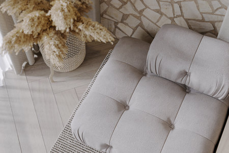 Dried flowers into a standing vase next to the modular sofa.の写真素材