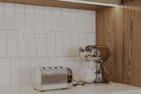 An electric toaster and coffee maker on the island in the kitchen.の写真素材