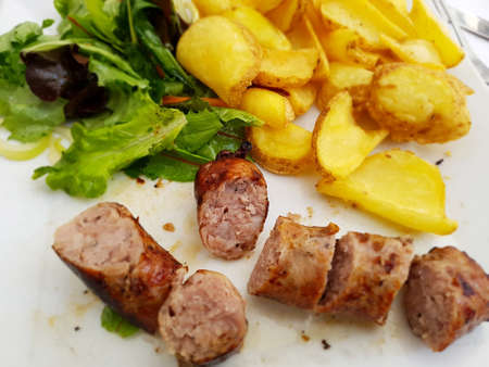 Typical Toulousse sausage with potatoes and saladの写真素材