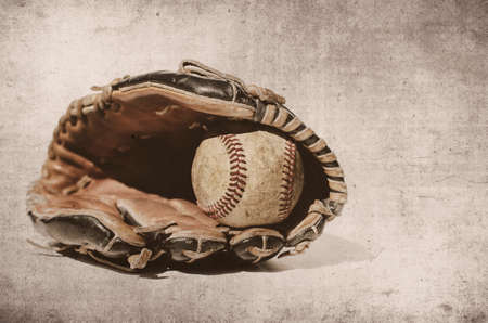 Old rugged baseball glove with ball.  Vintage style sport image with texture background.の写真素材